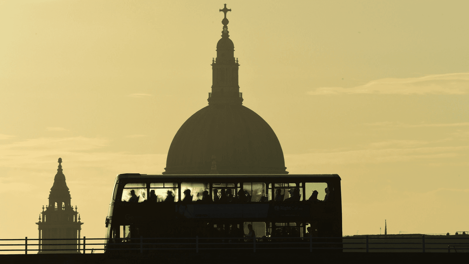 a bus carries commuters as it travels over Waterloo Bridge in London