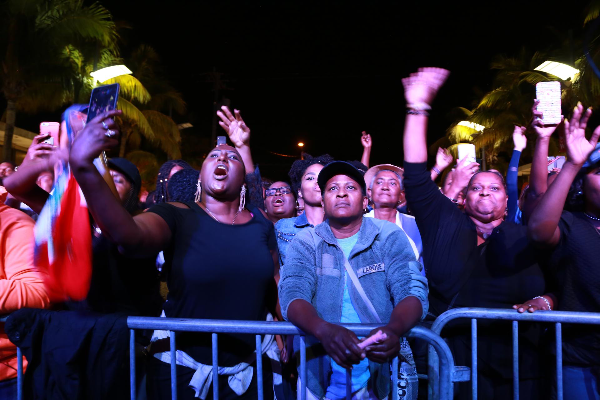People in the crowd in Miami, Florida dance during a set at the Bayo Block Party.