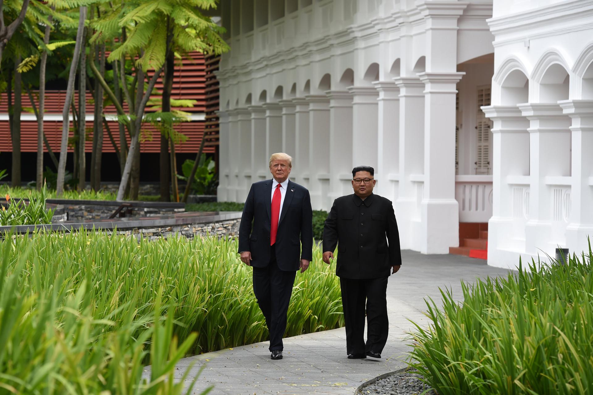 US President Donald Trump and North Korean leader Kim Jong-un walk in the lush, green gardens of Capella Hotel.