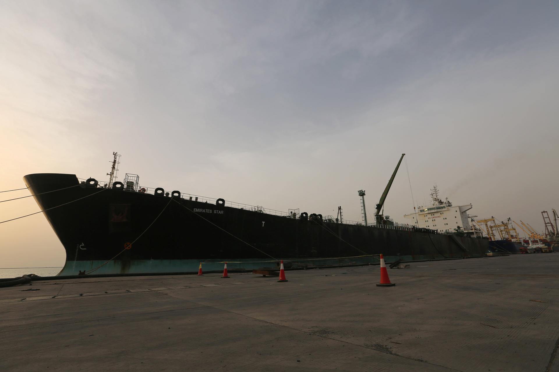 A cargo ship unloads a shipment of fuel at the Hodeida port, May 27, 2018.