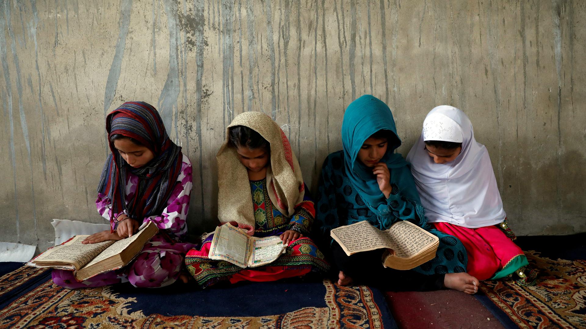 Afghan girls read the Quran in a religious school in Kabul, Afghanistan, May 28, 2018. Humanitarian organizations say 3.7 million children (44 percent) in Afghanistan are out of school — 2.7 million of them are girls.