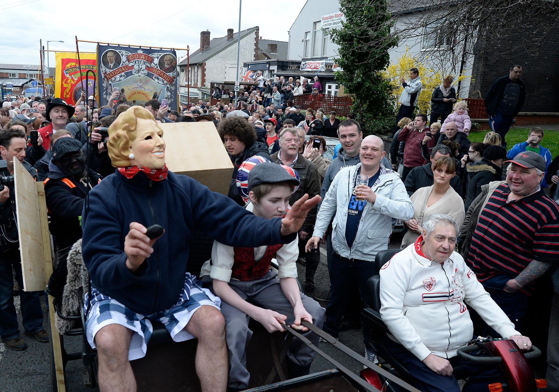 Parade with person in Margaret Thatcher mask
