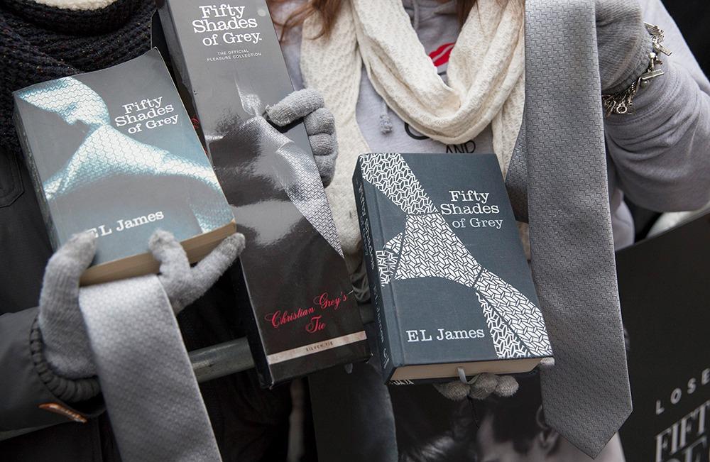 Fans pose with "Fifty Shades of Grey" paraphernalia at the film's UK premiere in London in 2015.