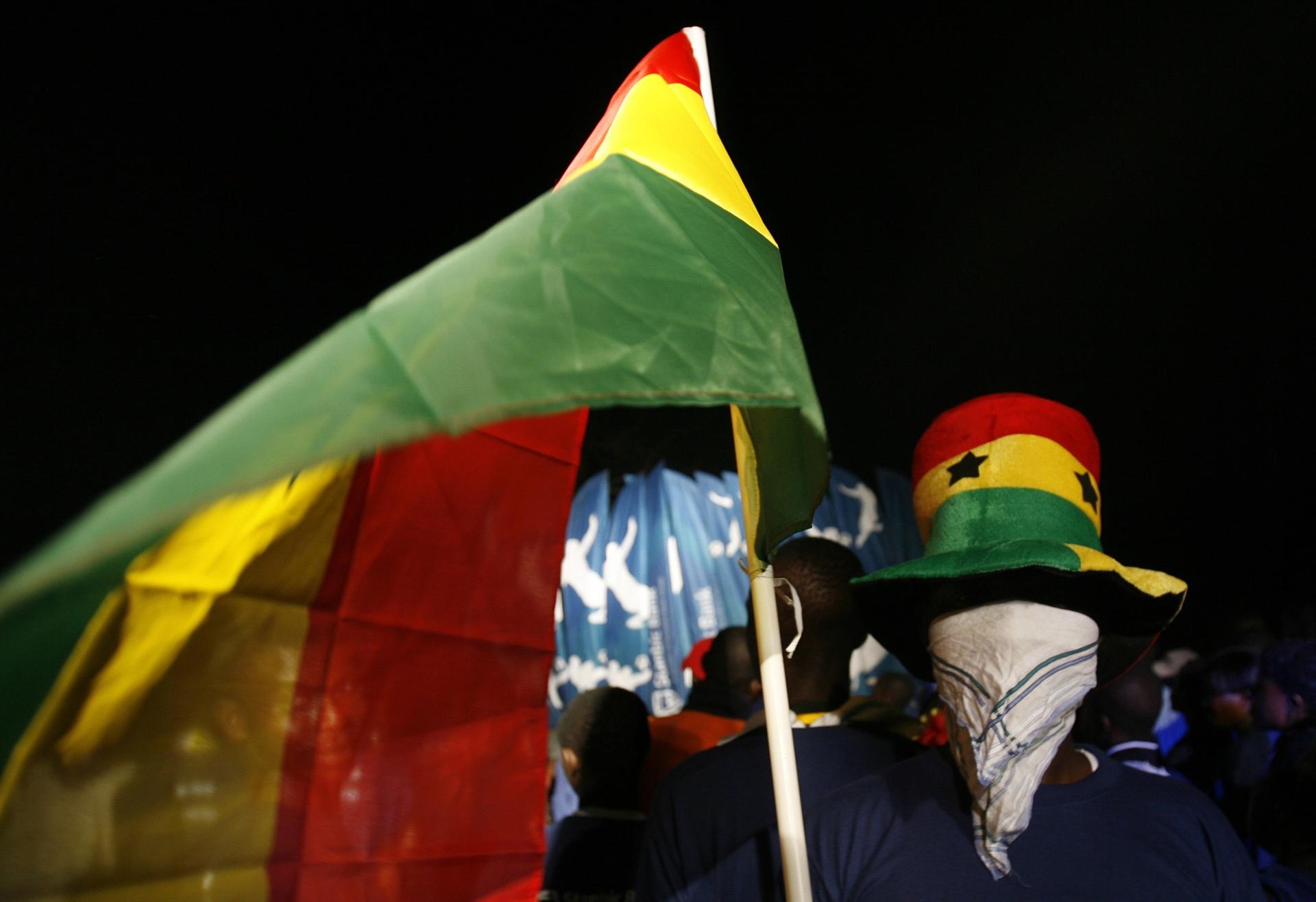 A man wearing a hat in the Ghanaian national colors