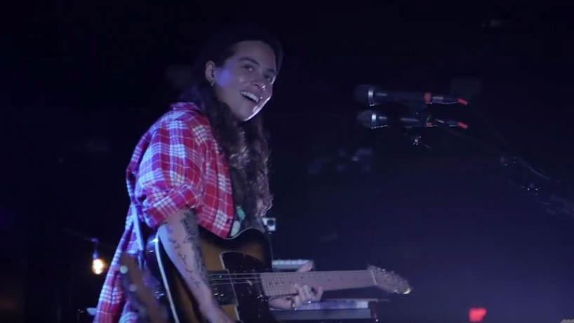 Tash Sultana is seen smiling on stage at the Paradise Rock Club in Boston.