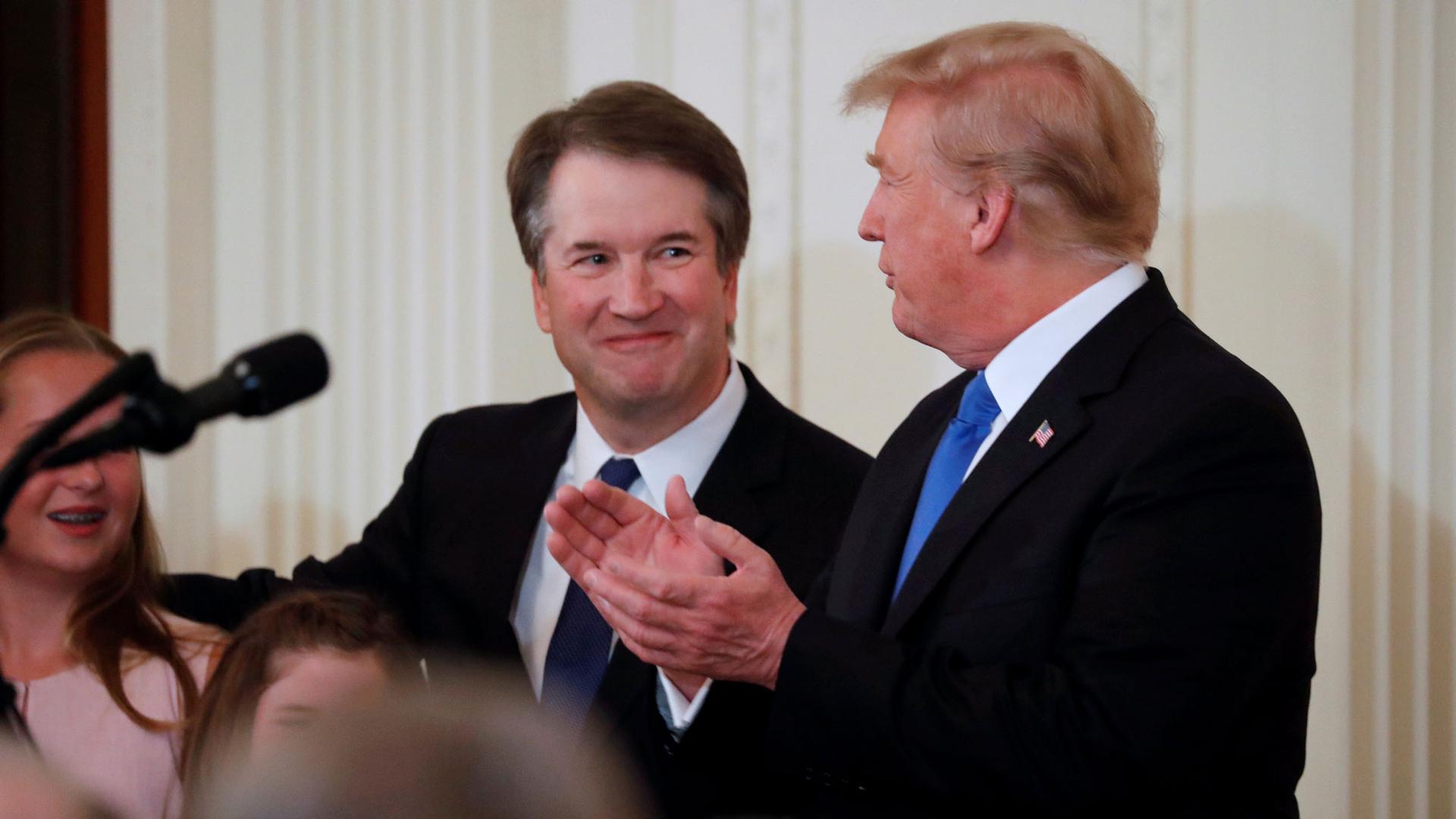 Supreme Court nominee Judge Brett Kavanaugh stands next to left of US President Donald Trump in the East Room of the White House in Washington, DC, on July 9, 2018, during Trump's announcement of his Supreme Court pick.