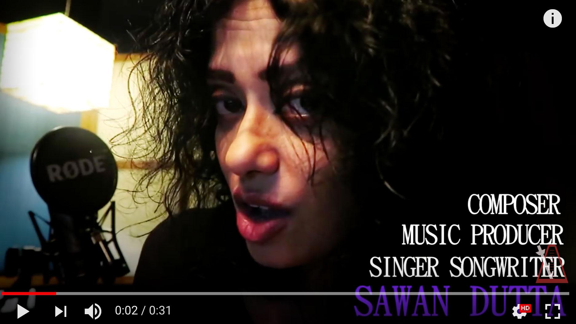 A woman is talking into a screen next to a microphone in a dark room. On the right, words say, "composer, music producer, singer songwriter Sawan Dutta"