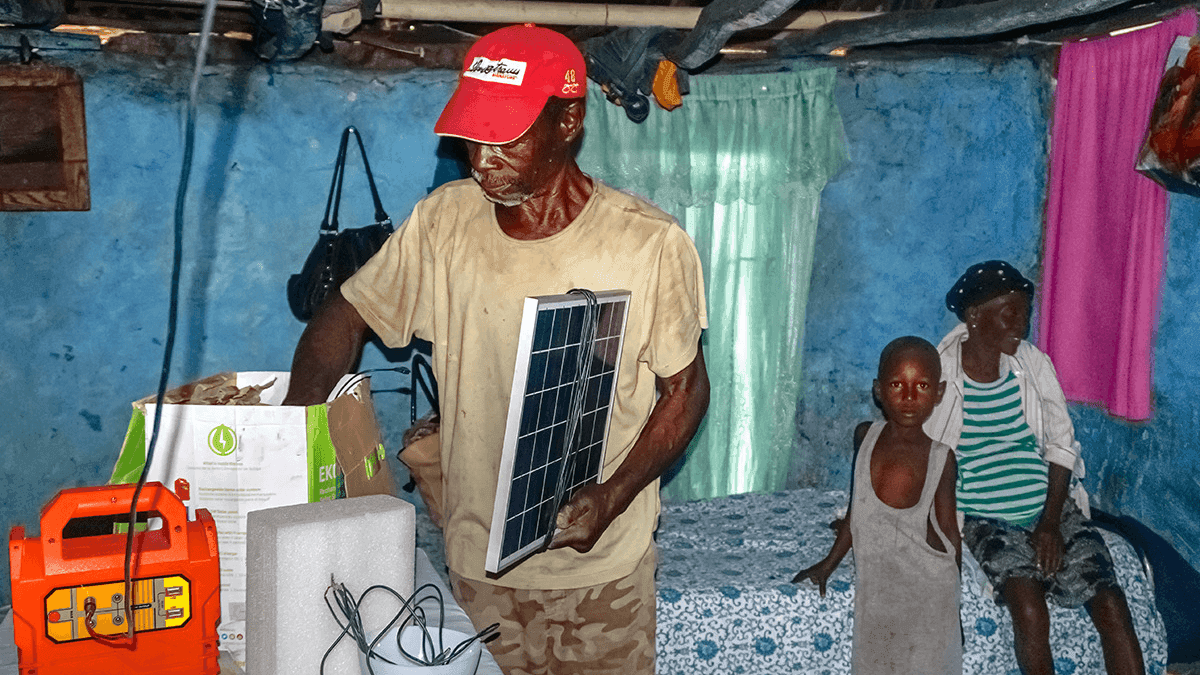 a farmer living in Chansolme, shows off the solar-powered lighting equipment he purchased in November through the government’s “Ma Maison Eclairée” initiative.