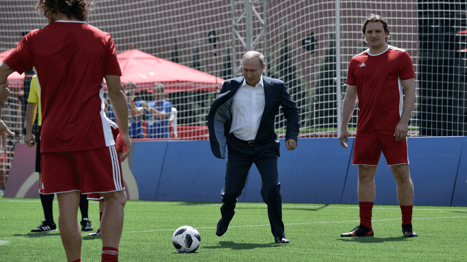 russian president vladimir putin kicks a soccer ball