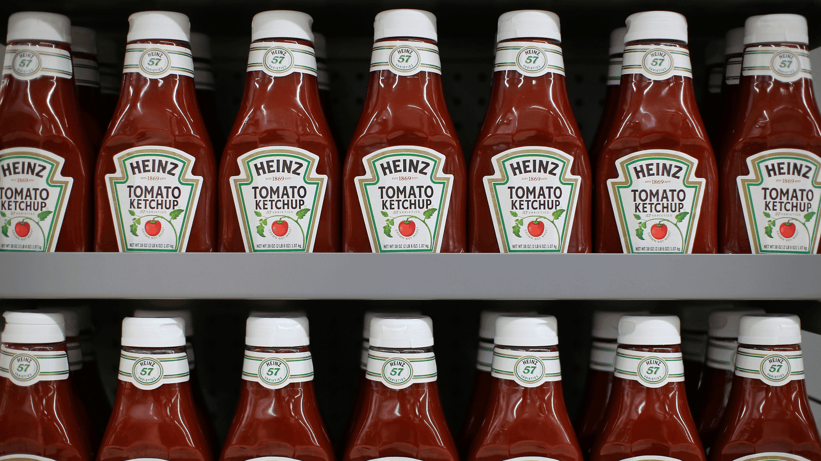 bottles of ketchup on a supermarket shelf