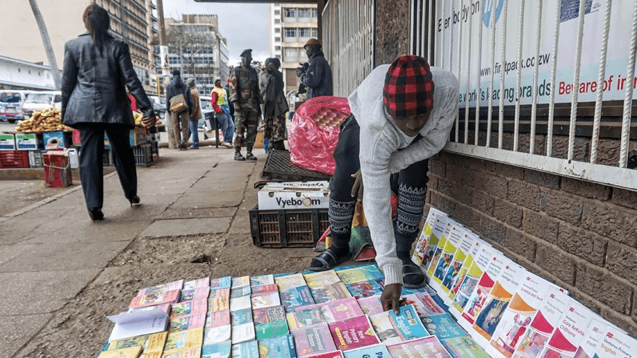 Darlington Chindoko, 22, sells textbooks on a street in Harare, Zimbabwe’s capital city. The books are scarce in public schools so many parents buy them for their children.