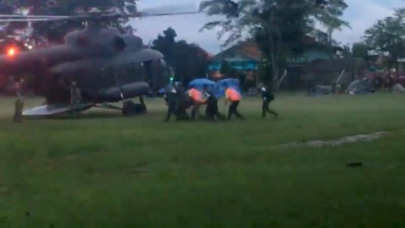Paramedics, believed to be carrying a boy who has been evacuated after being trapped inside a flooded cave, approach a helicopter in Chiang Rai, Thailand, July 8, 2018, in this still image obtained from social media.
