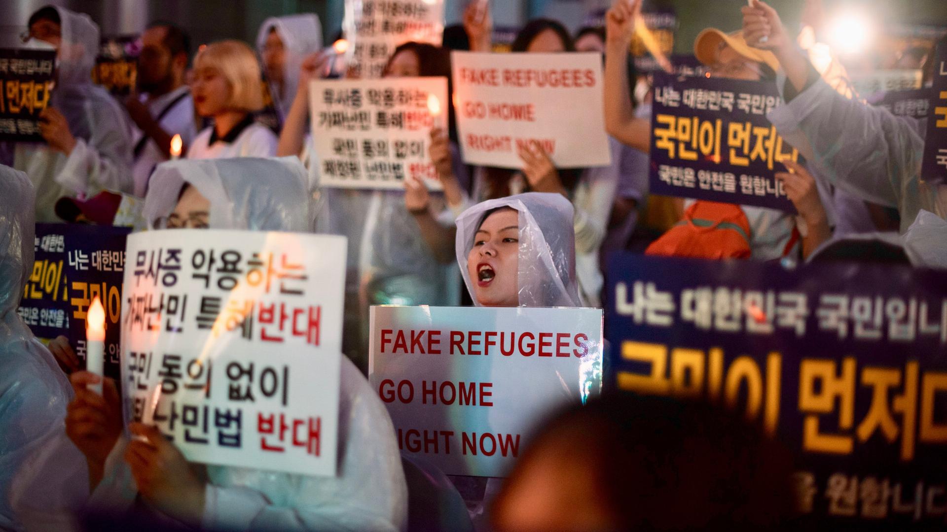 Anti-immigration activists attend a protest in the South Korean capital of Seoul on June 30, 2018. They were protesting against a group of hundreds of Yemeni asylum-seekers who arrived on the South Korean tourist resort of Jeju Island in recent months. Th