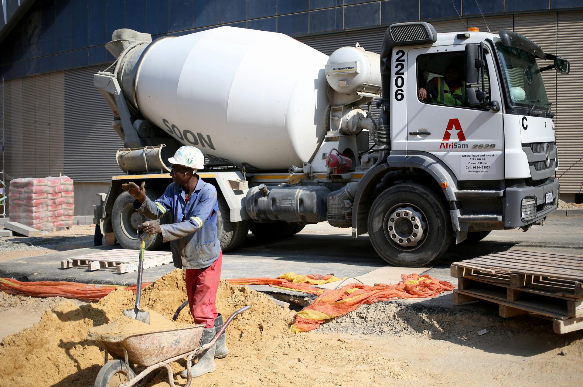 Worker in front of cement truck