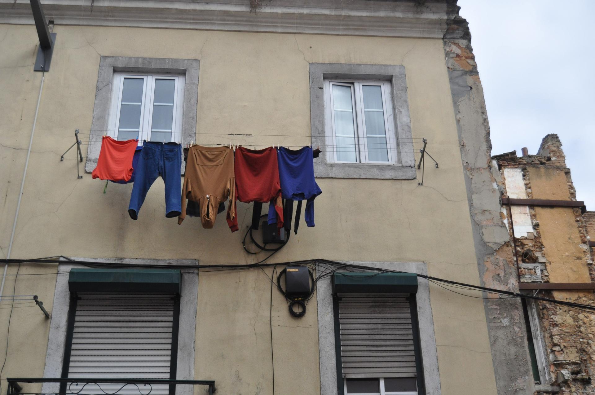 wash hanging from a window in lisbon
