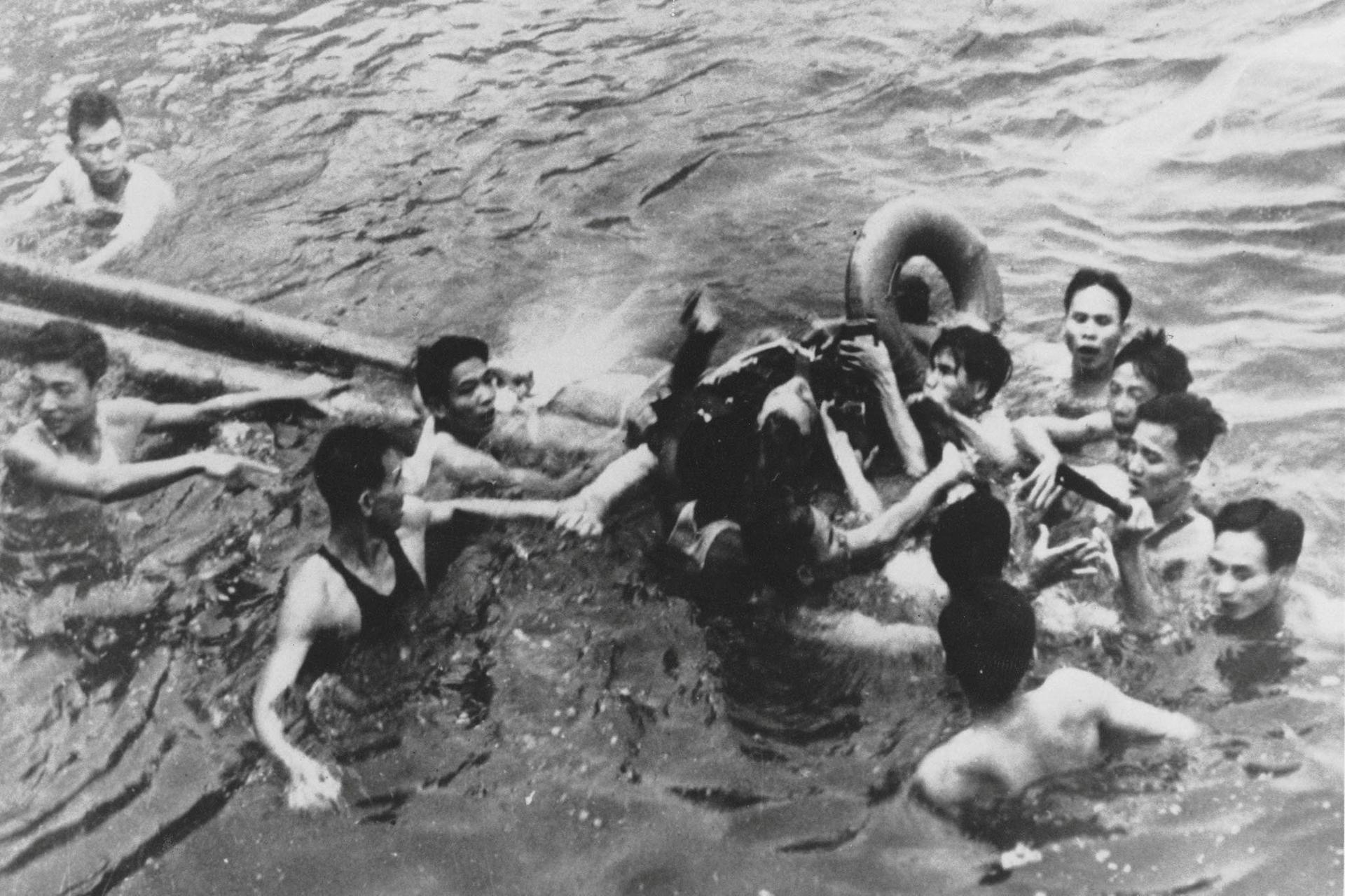 John McCain is pulled out of a Hanoi lake by a mix of North Vietnamese Army (NVA) and Vietnamese citizens