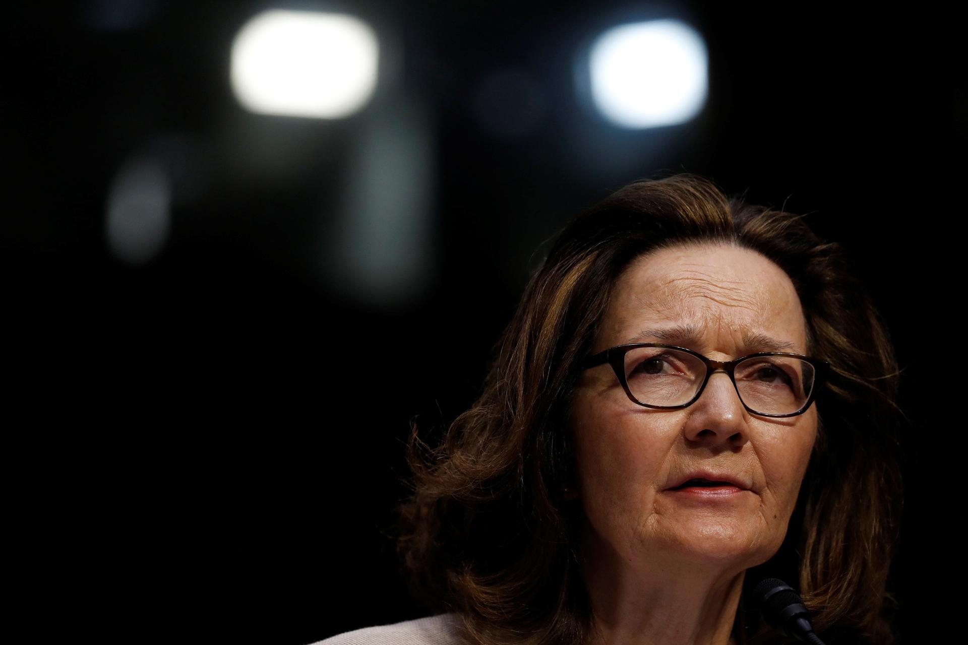 CIA Director Gina Haspel, wearing dark rimmed glasses, looks right in the medium cropped portrait.