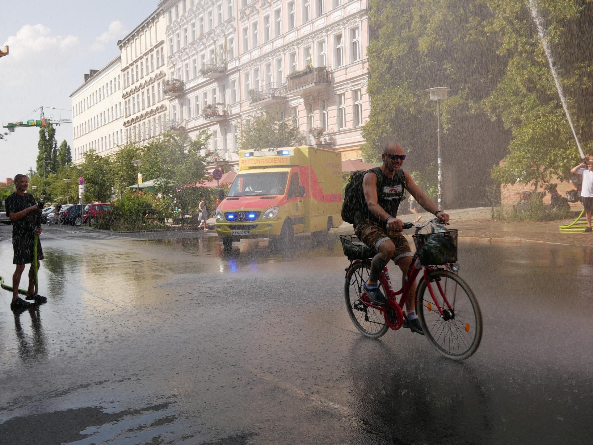 Firefighters blast water in Berlin in mid-August, providing relief from the heat. This is among the few ways to cool off in a city with little air conditioning.