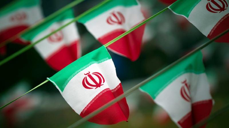 Iran's national flags are seen on a square in Tehran. 