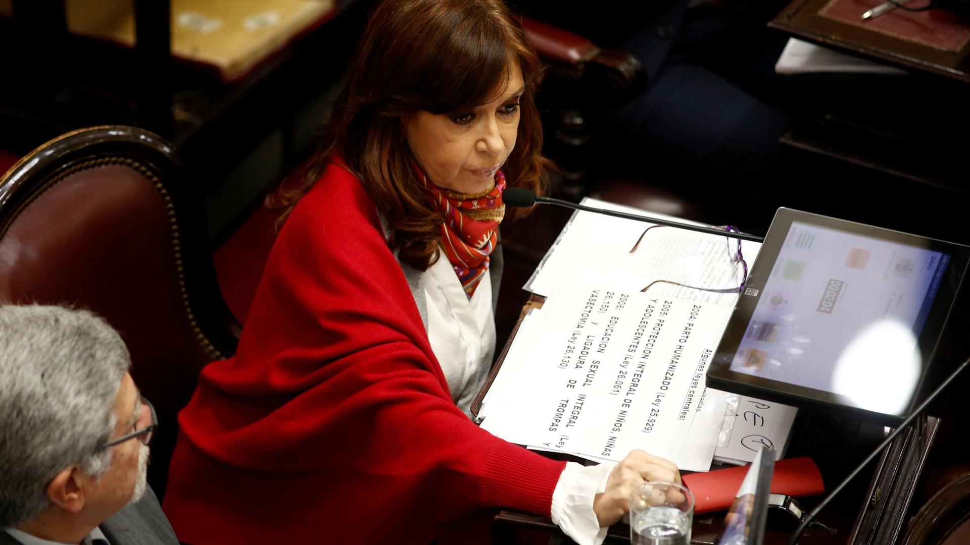 Senator and former Argentine President Cristina Fernandez de Kirchner sits next to Senator Marcelo Fuentes as lawmakers debated a bill that would have legalized abortion, in Buenos Aires, Argentina, August 9, 2018.