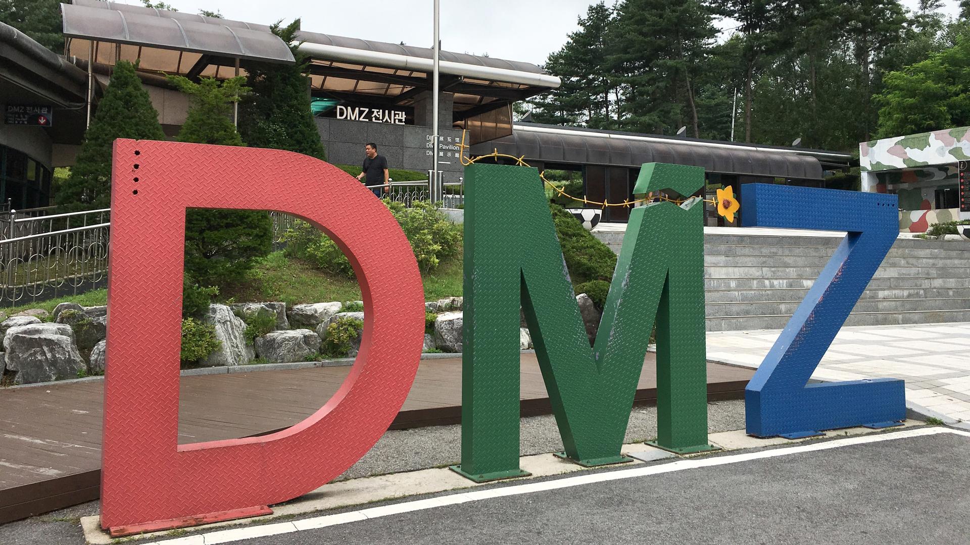 an old building with large DMZ letters out front 