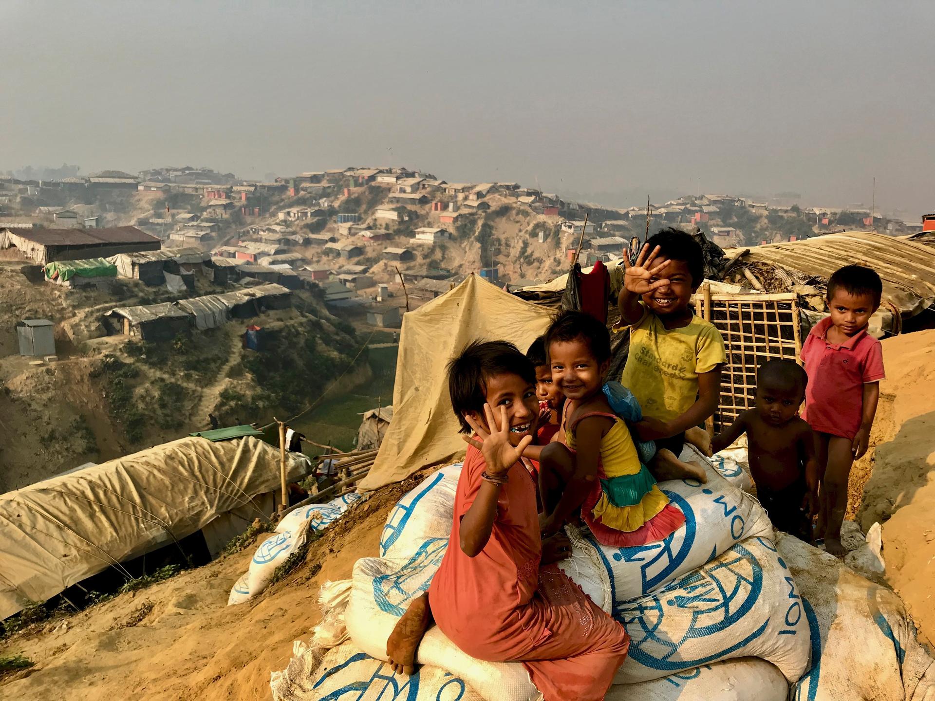kids at the edge of a Rohingya refugee camp