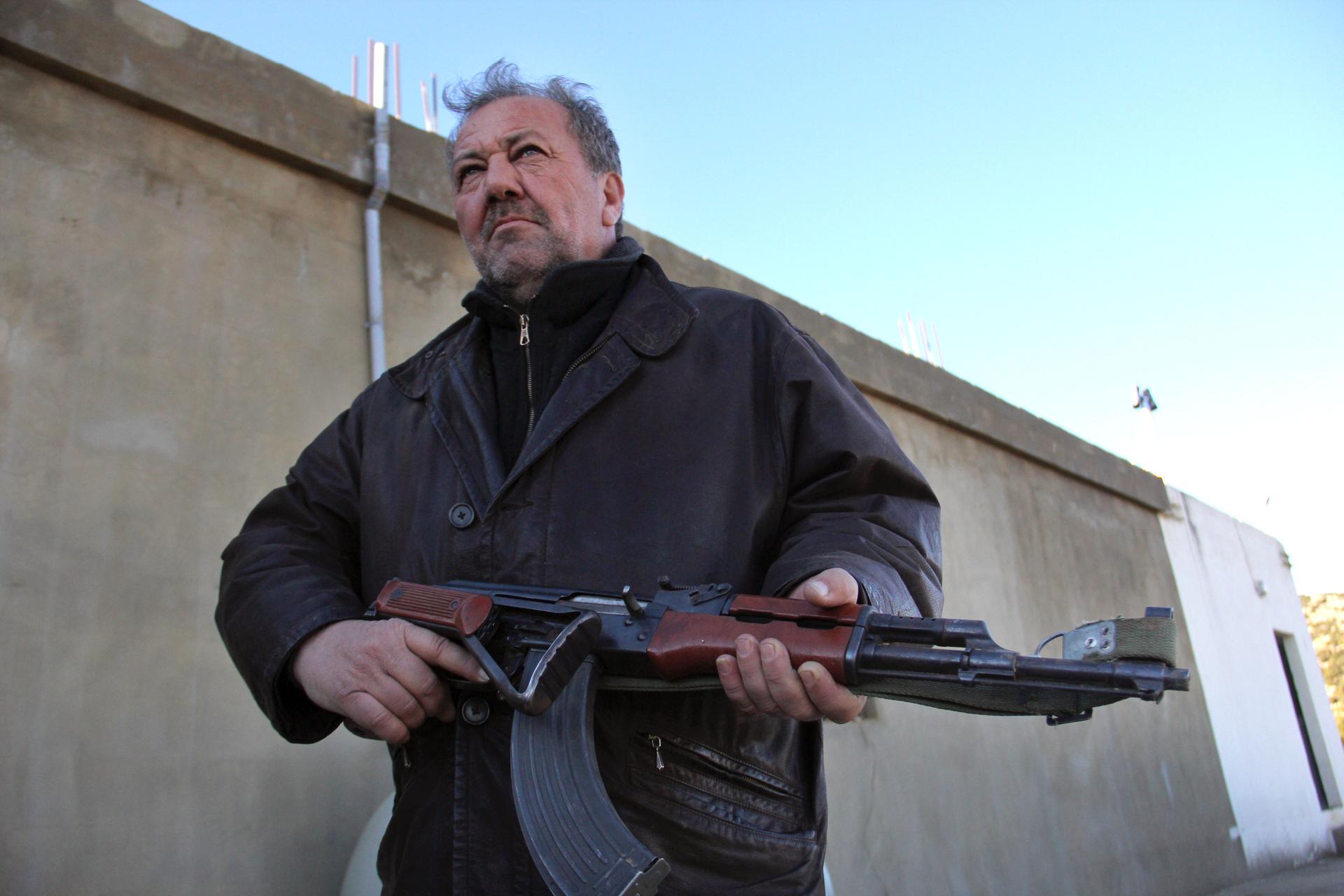 a man shown with a large gun