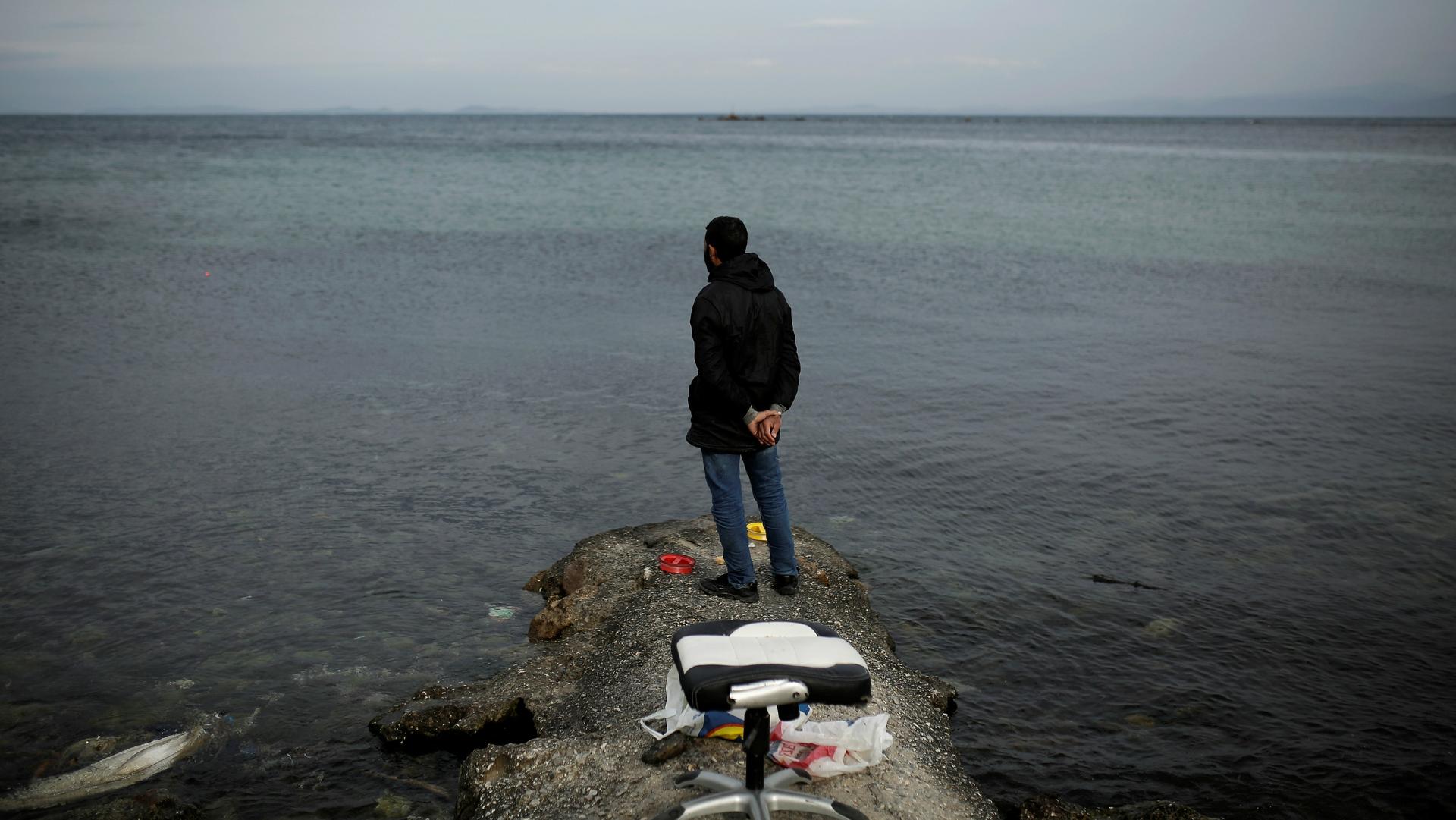 Syrian refugee Muhammad, 42, looks at the sea while fishing in the city of Mytilene, on the island of Lesbos, Greece, Dec. 2, 2017.  