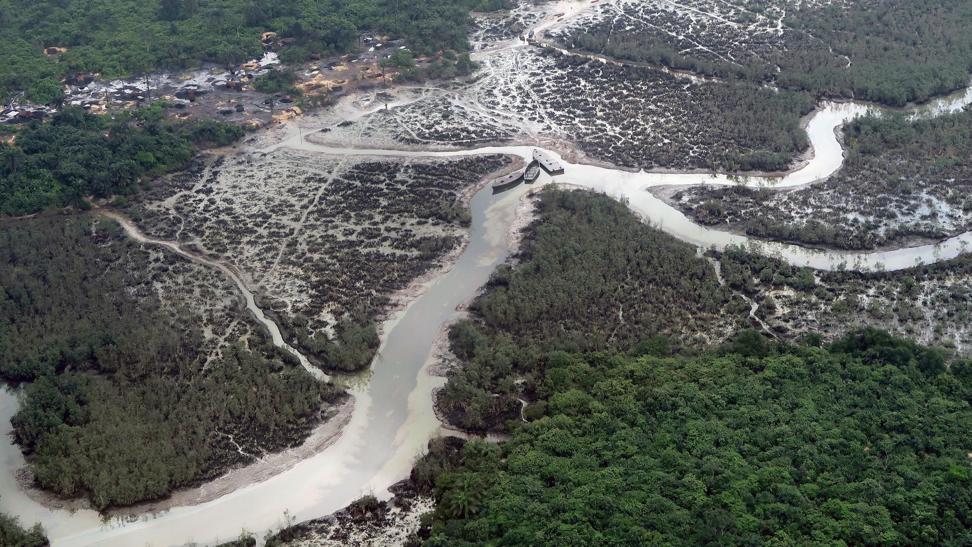 An aerial photo shows oil spills in a river delta