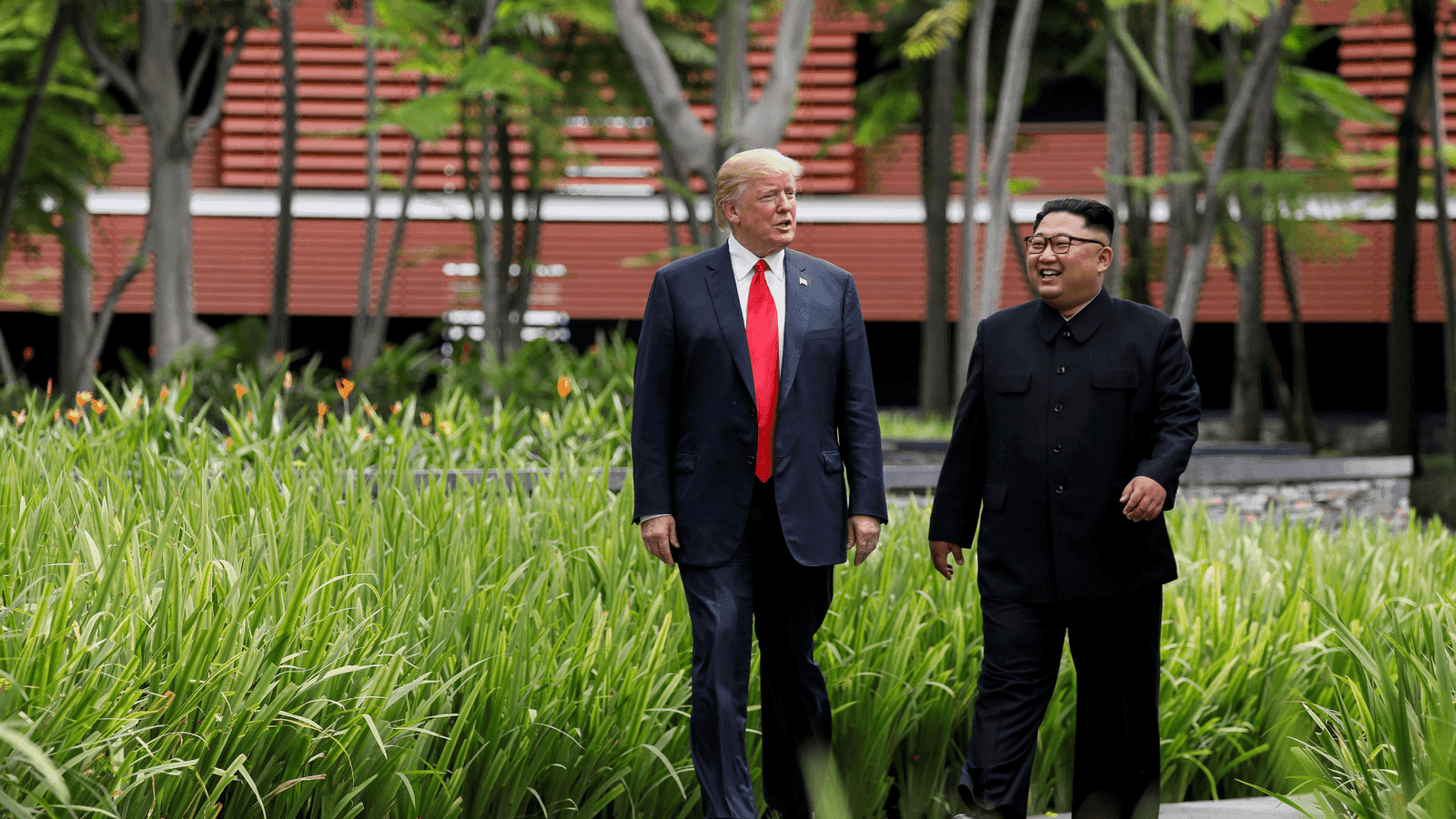 Donald Trump and Kim Jong-un walk together