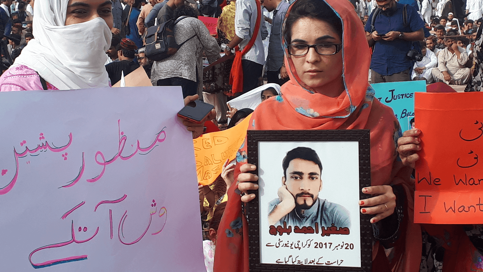 Pashtun women in Pakistan hold posters of their missing family members
