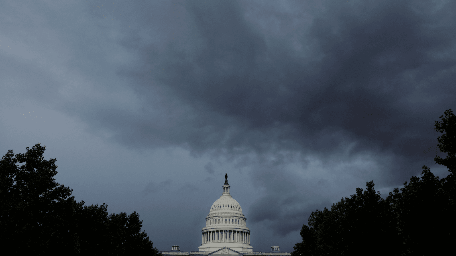 the US capitol under dark clouds