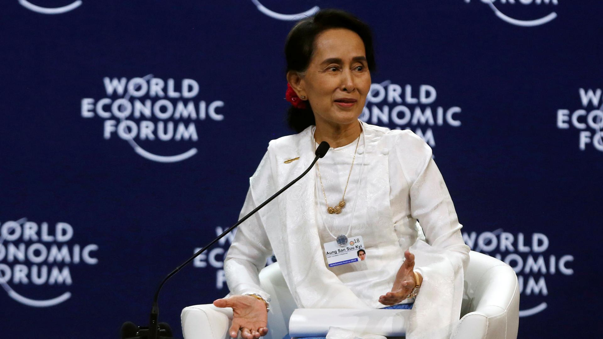 Aung San Suu Kyi  on a stage dressed in white