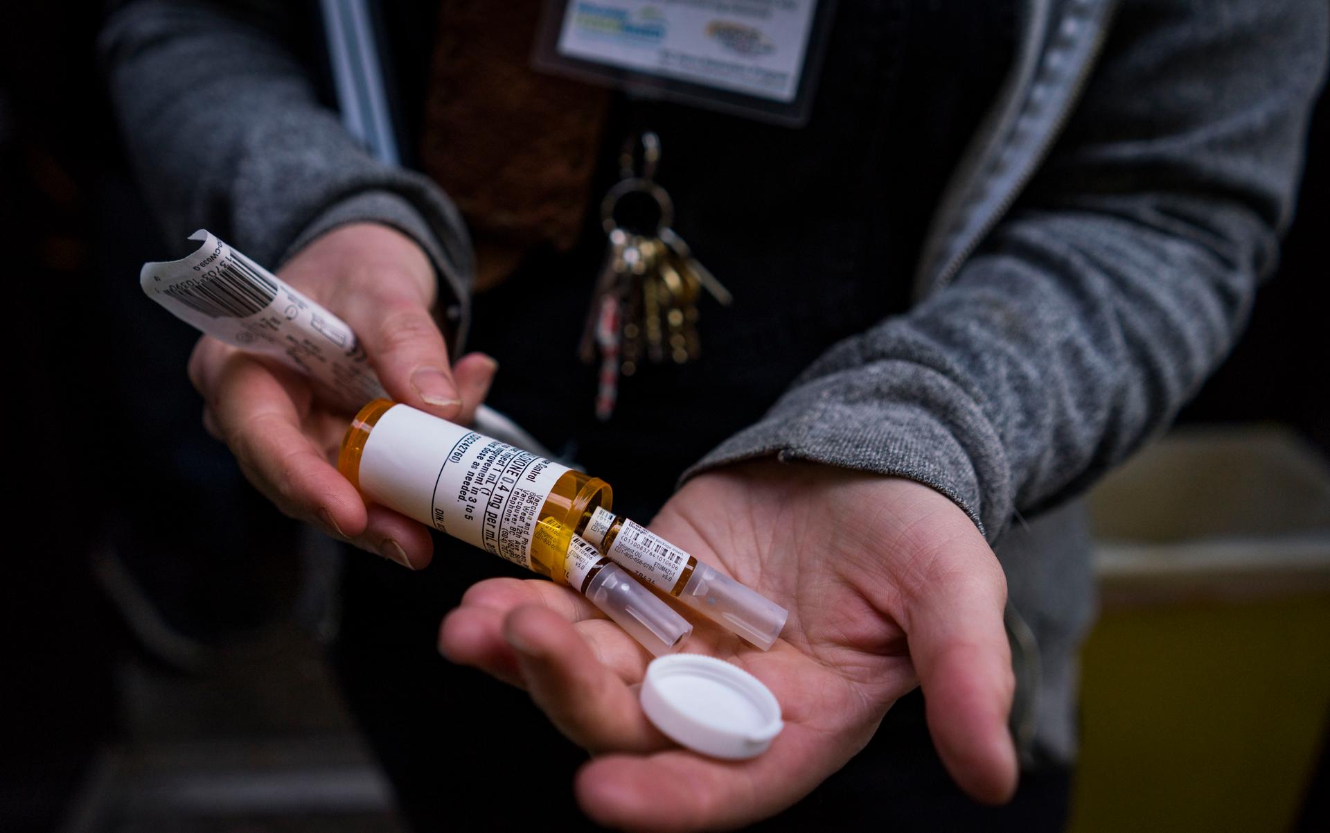 an overdose naloxone kit in a woman's hands