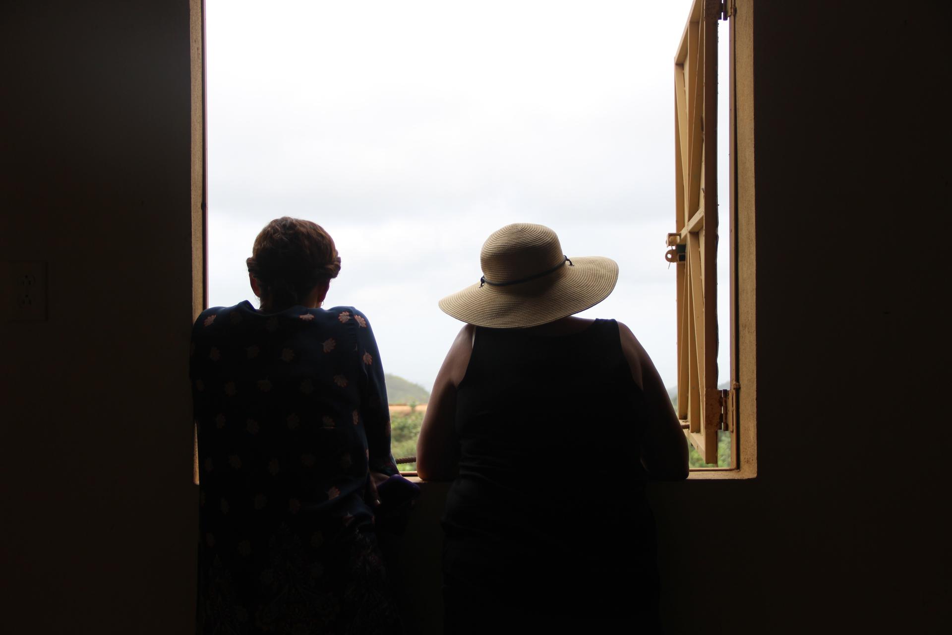 two women looking out of window