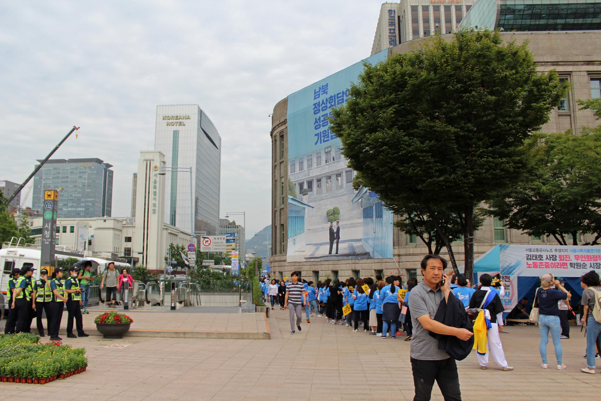 a man walks near seoul city hall