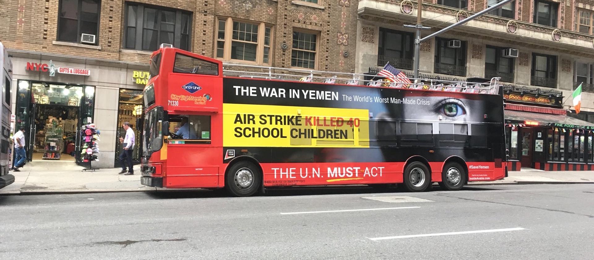 This bright red New York City tour bus carries a message about the war being fought in Yemen.