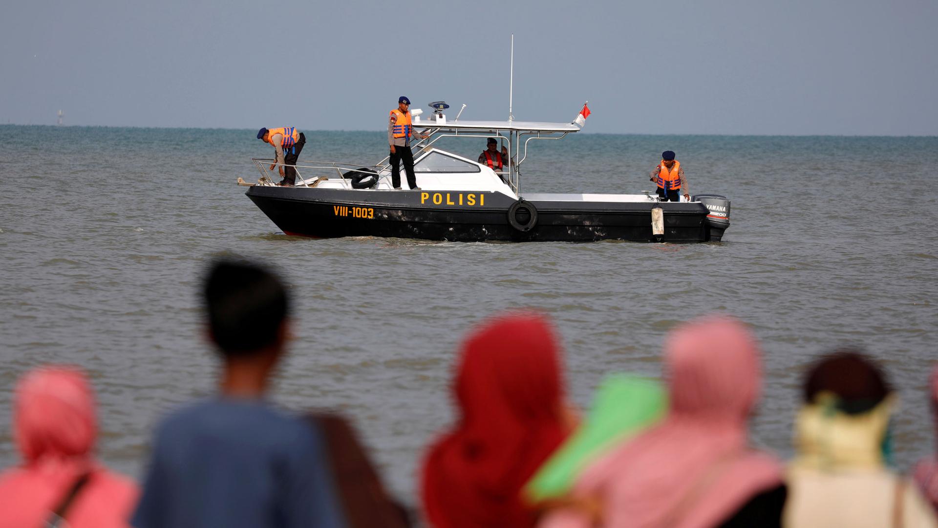 A rescue team aboard a boat is shown heading out to the Lion Air flight JT610 sea crash location. 