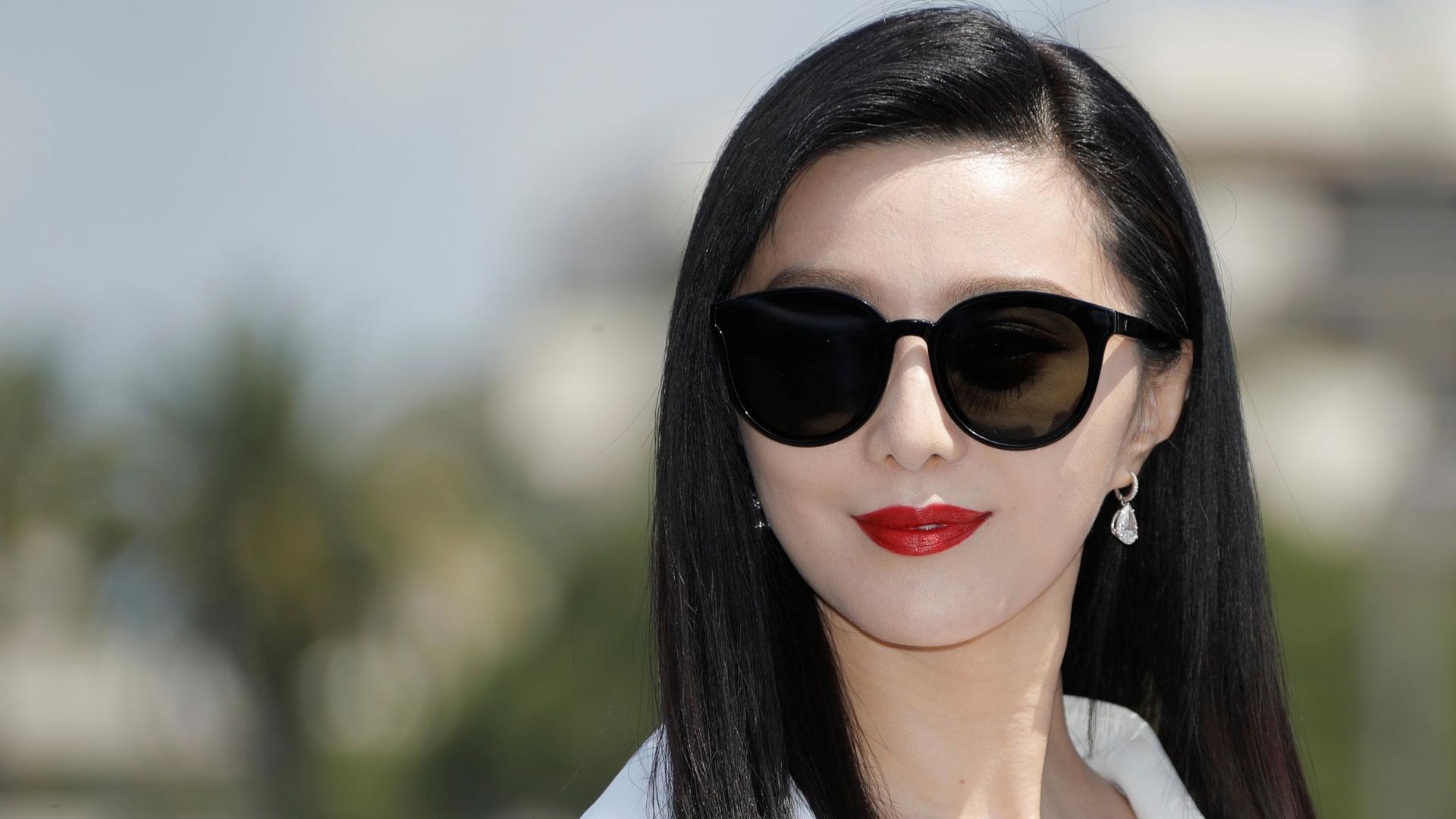 Fan Bingbing is shown in a close-up portrait photo with dark sunglasses on.
