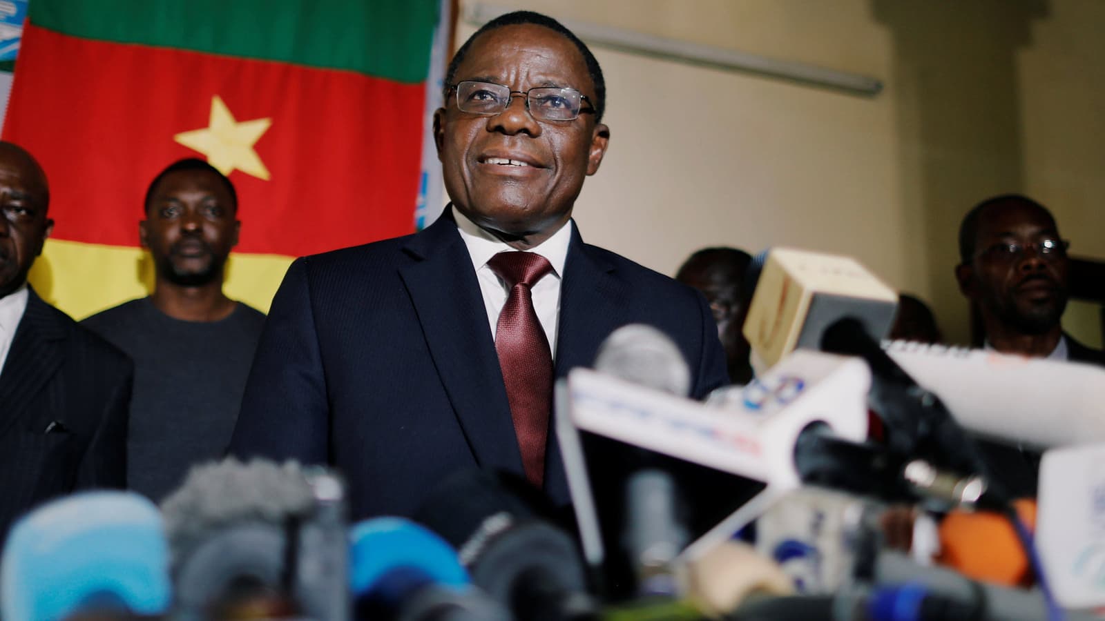 Cameroon opposition candidate smiles during a news conference at his headquarters in Yaoundé, Cameroon