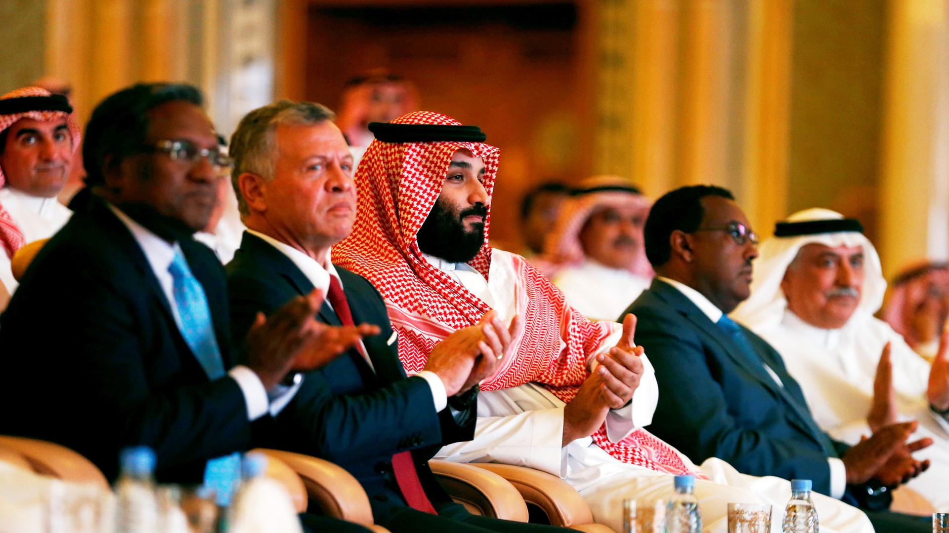 Saudi Crown Prince Mohammed bin Salman (center) is shown sitting in a row along with Jordan's King Abdullah II ibn Al Hussein.