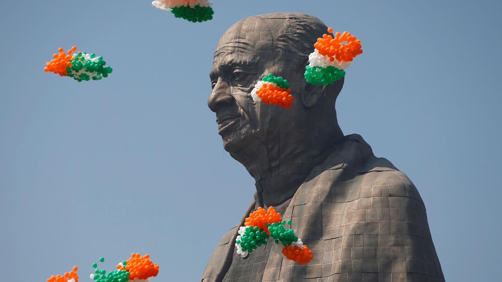Indian tri-colored balloons fly around a statue head of Indian founding father Sardar Vallabhbhai Patel