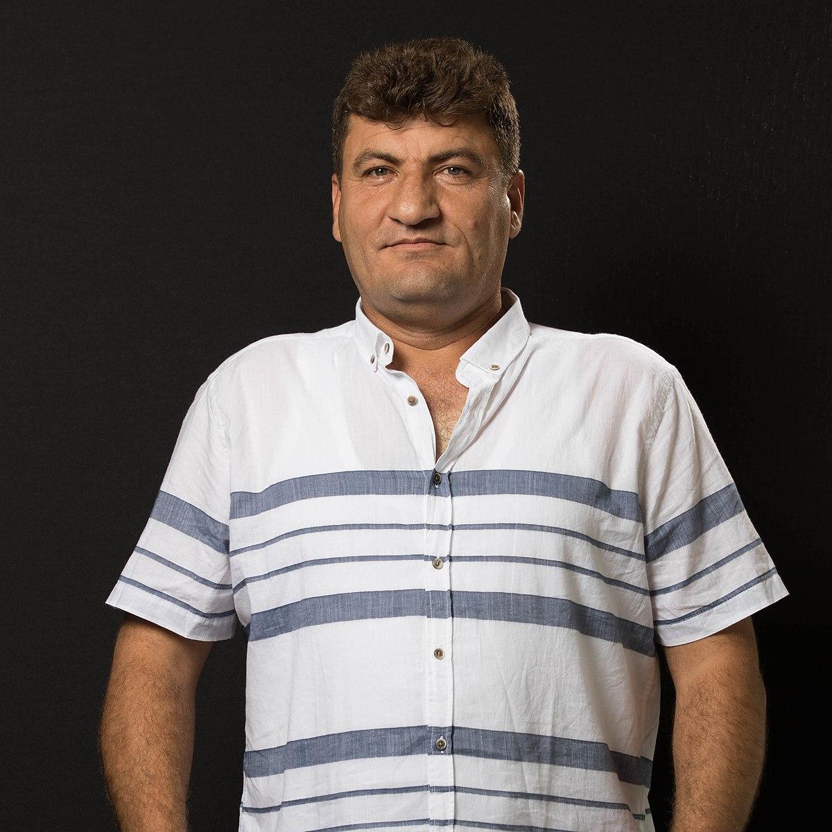 Raed Fares in front of a black background