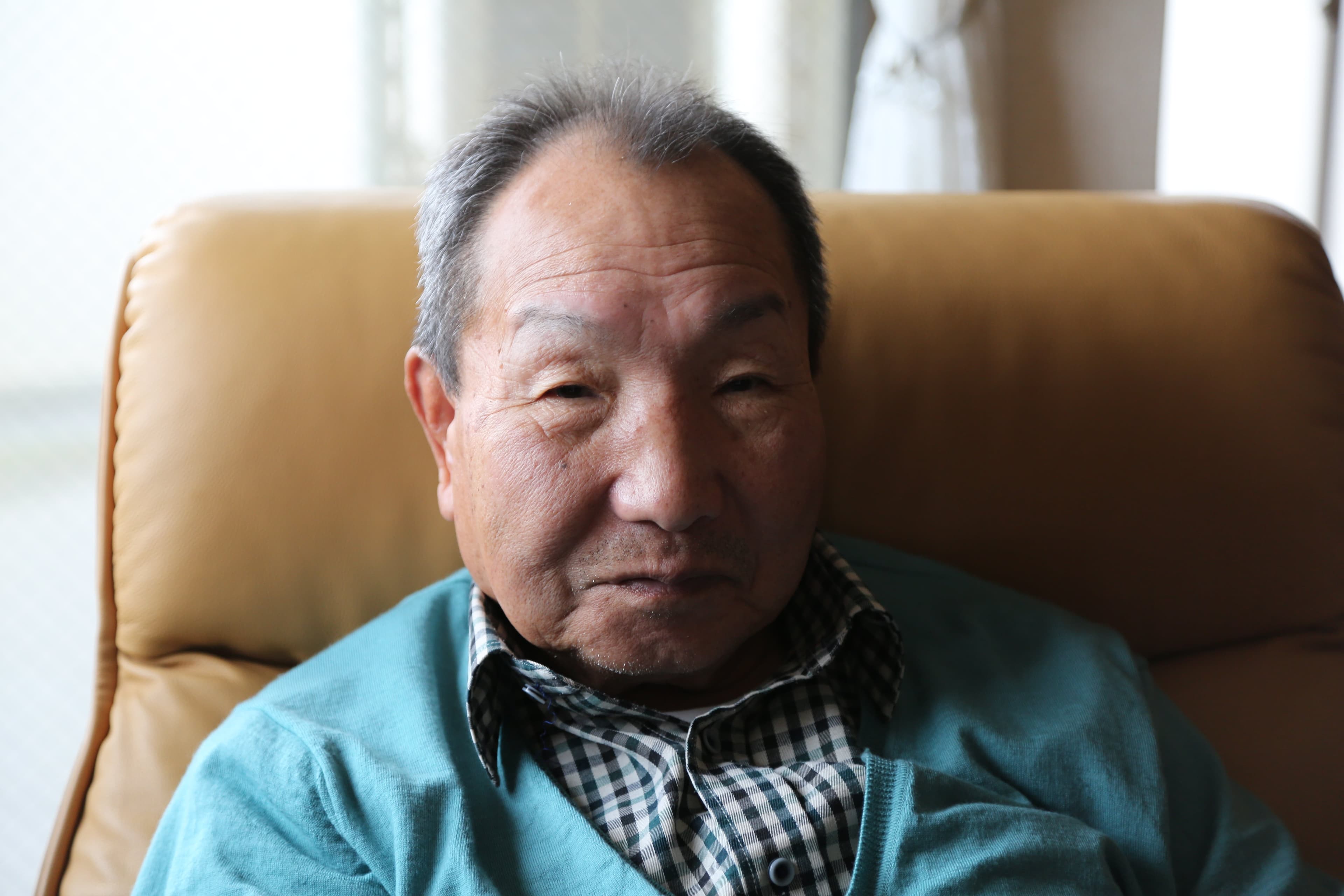 a closeup of Iwao Hakamada's face