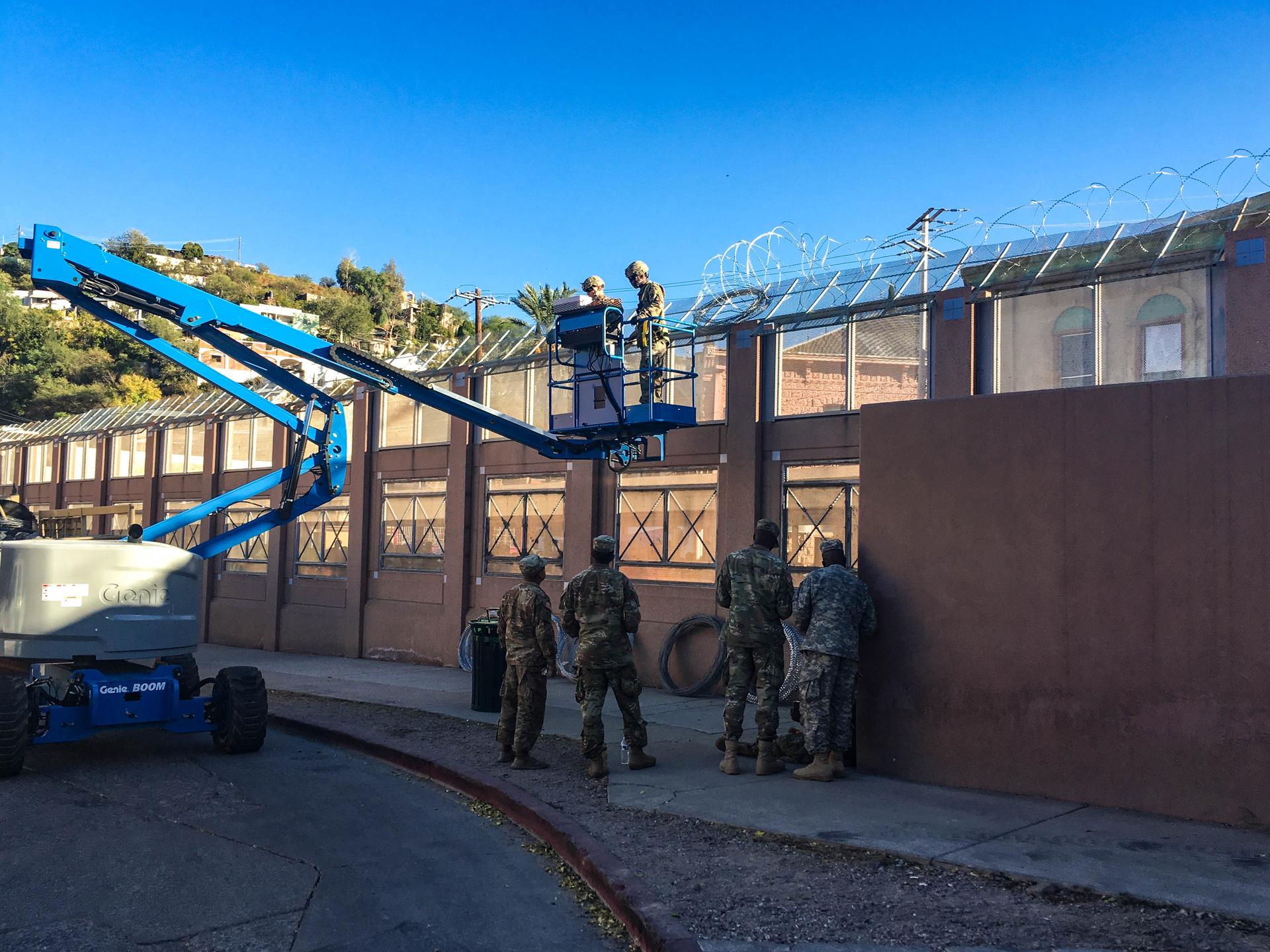 US Army soldiers install razor wire