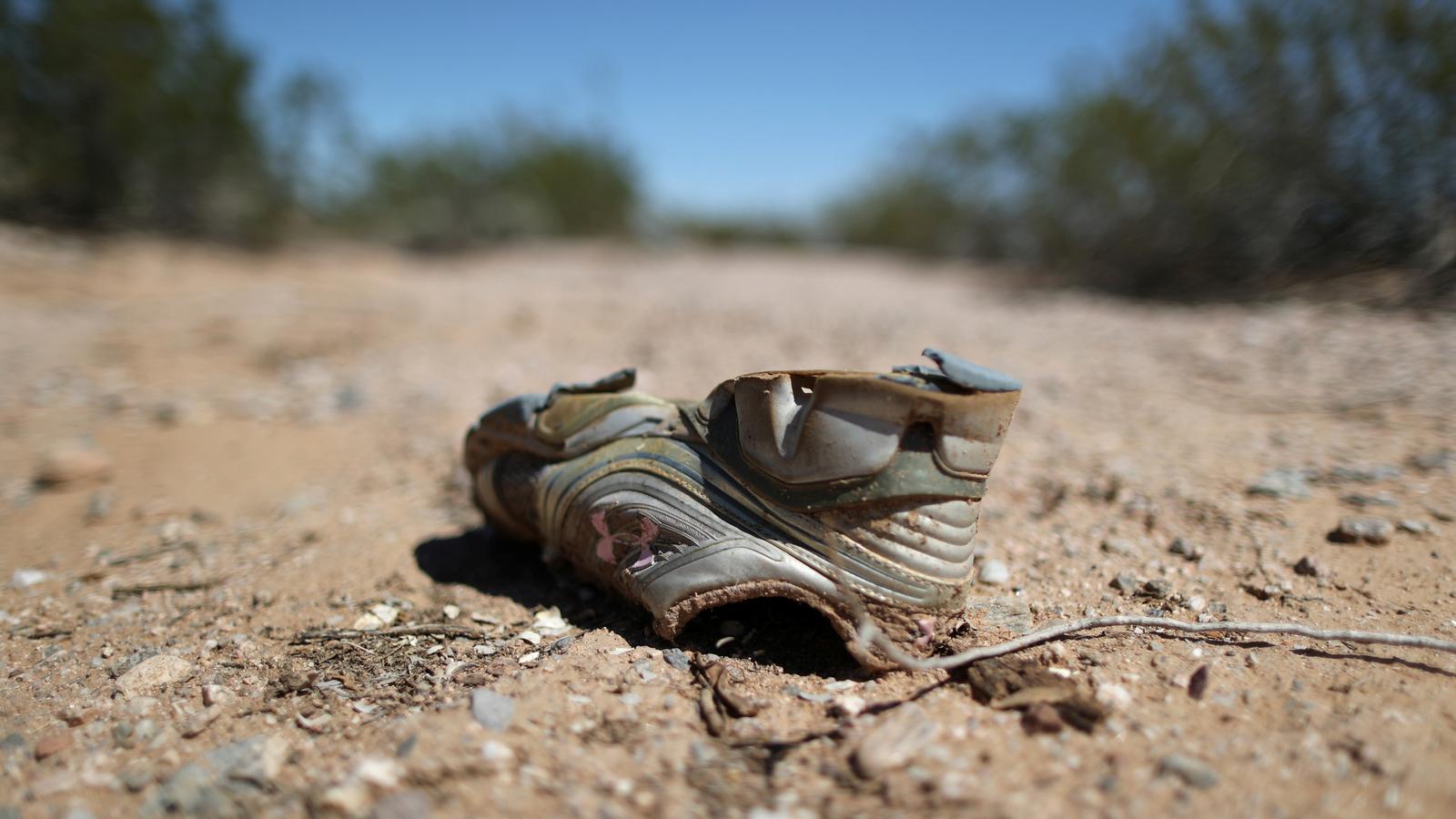 A worn shoe in the desert.