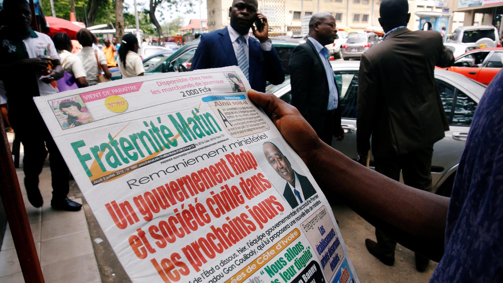 An Ivory Coast man reads a newspaper.