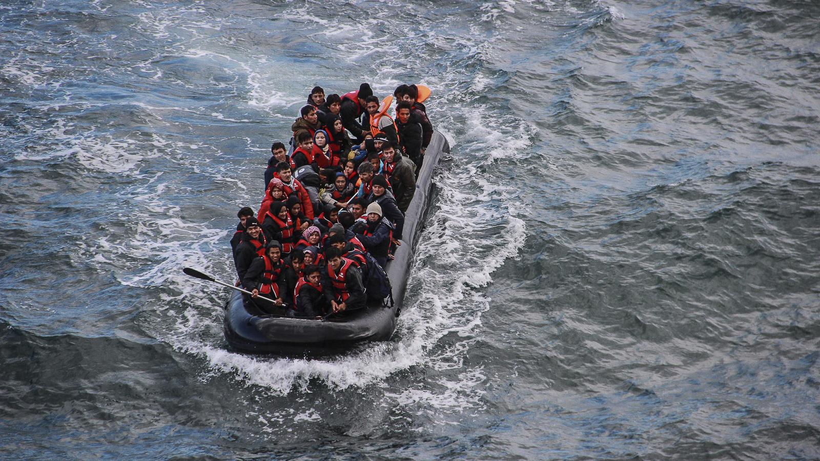 Refugees packed on a boat in the sea.