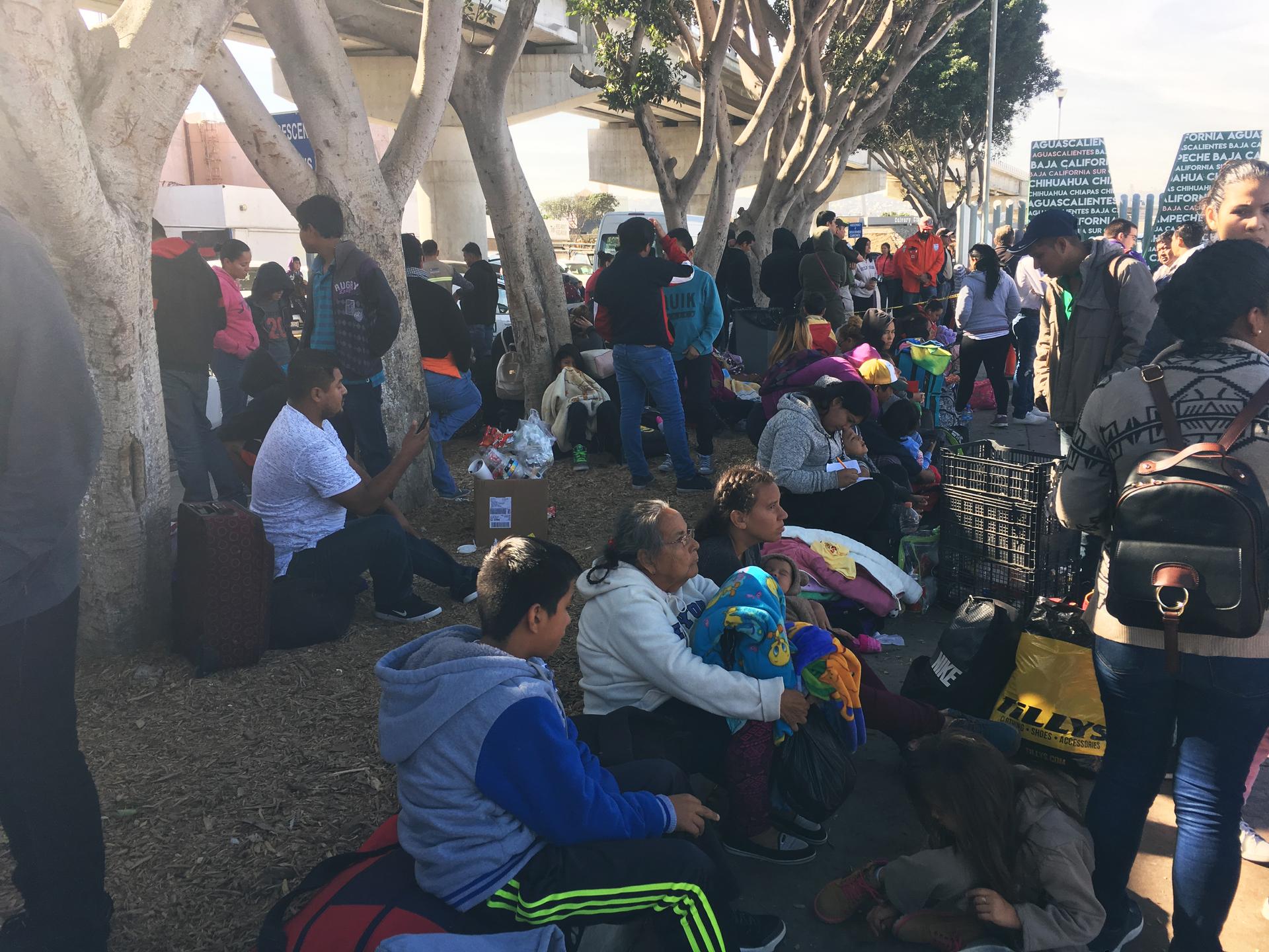 Families wait outside the port of entry to see where the are on the list, and when they can apply for asylum