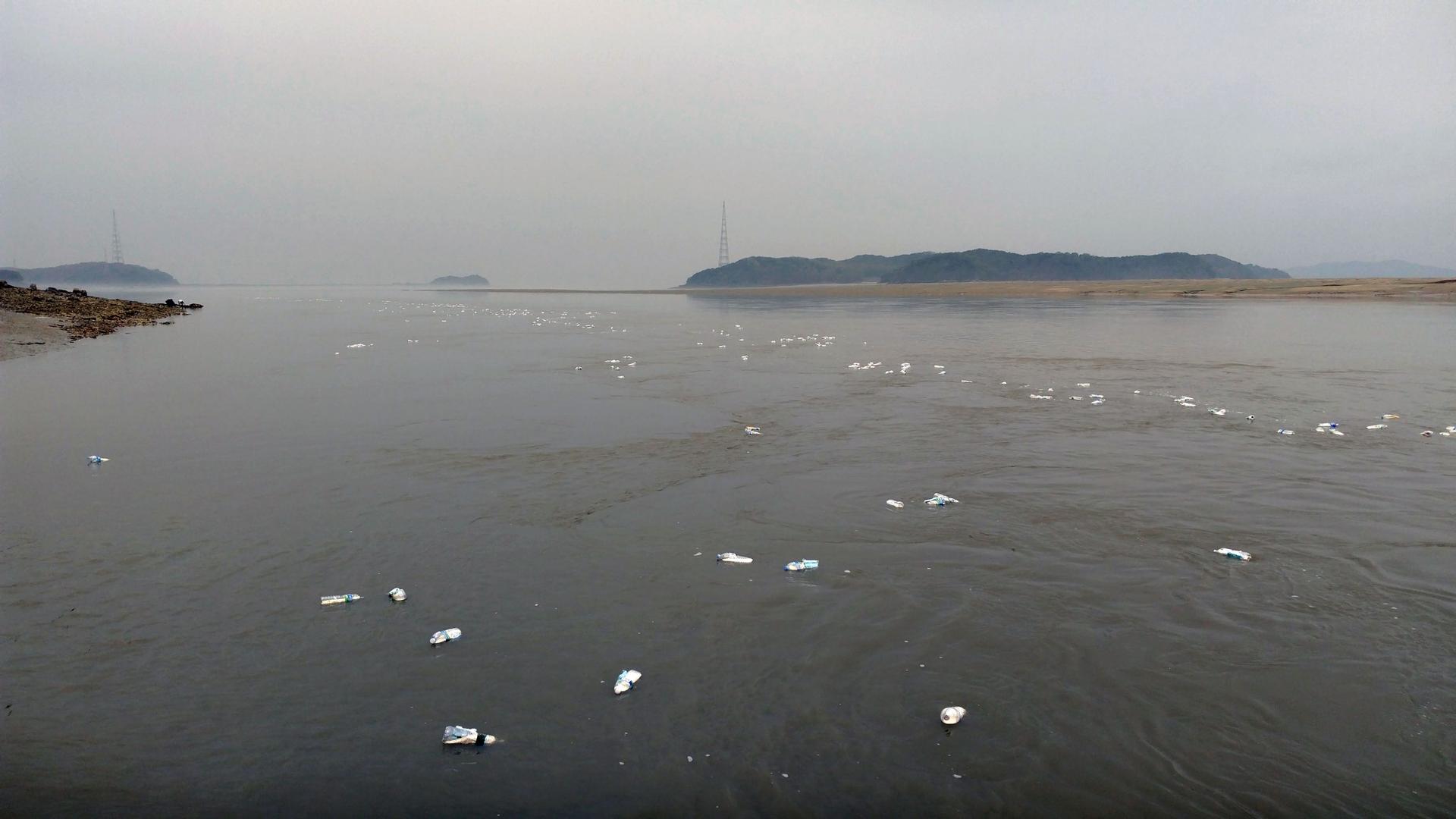 Dots of white are water bottles filled with rice and USB drives as they float in the sea, hopefully washing up in North Korea.